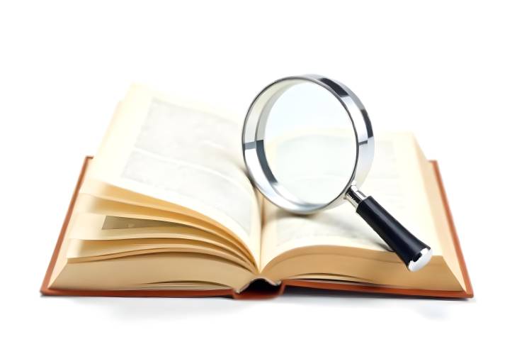 Magnifying Glass Over Book for Focused Research on White Background